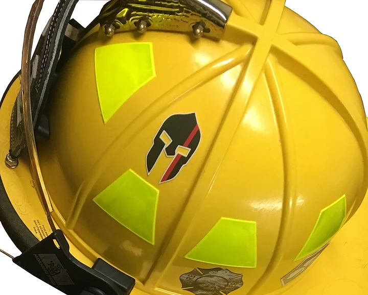 The side of John R Kowalski's volunteer firefighter helmet depicts a sticker of a Spartan helmet.