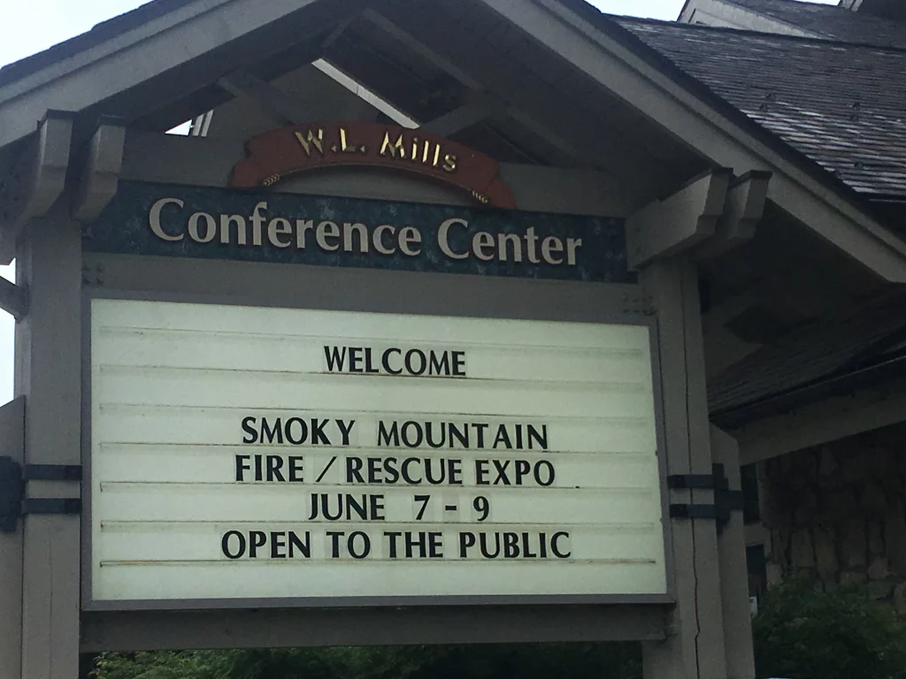 The WL Mills Conference Center sign reads, "Welcome Smoky Mountain Fire/Rescue Expo. June 7-9. Open to the public."