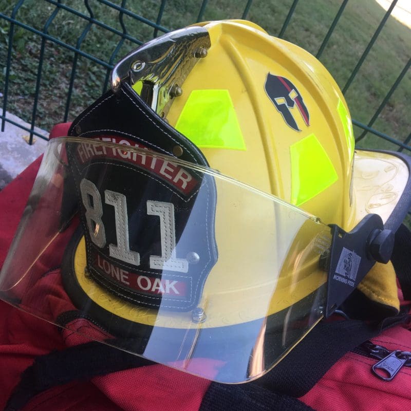 John R Kowalski's firefighter helmet reads, "Firefighter 811, Lone Oak."